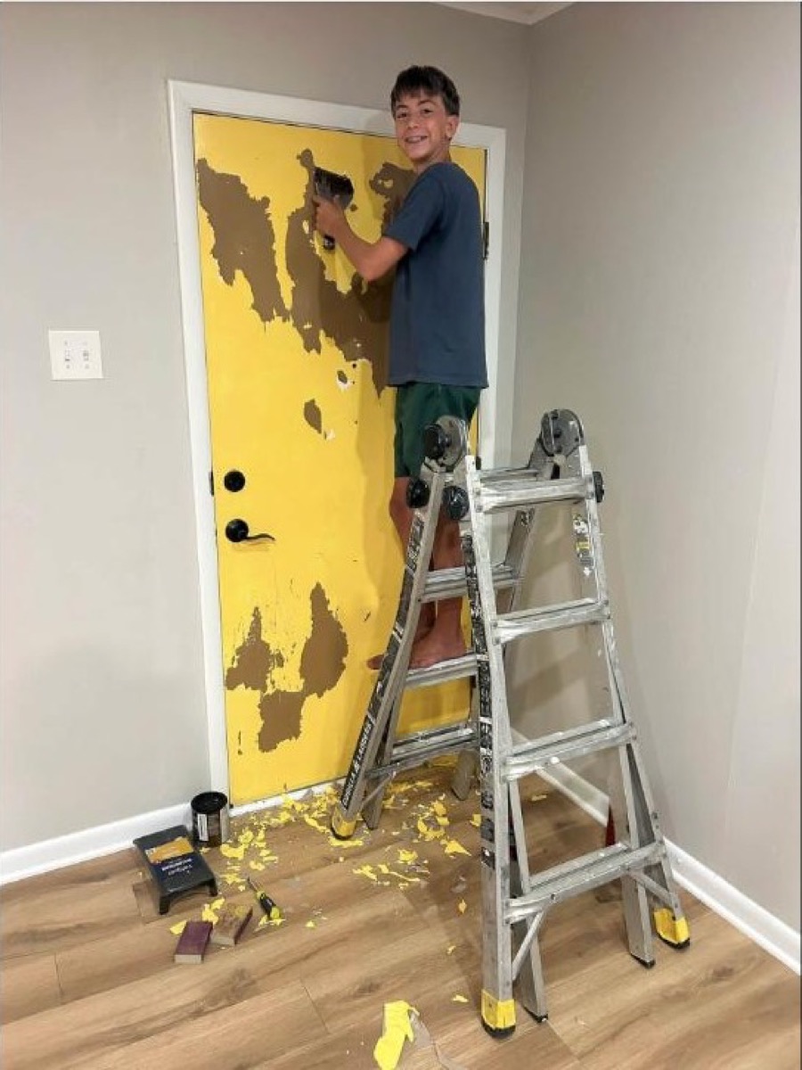 Daniel's eldest son helping refinish a door
